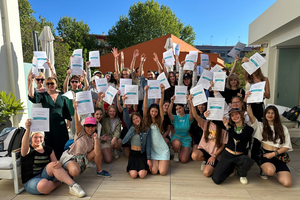 Spanish students from a school group holding a diploma